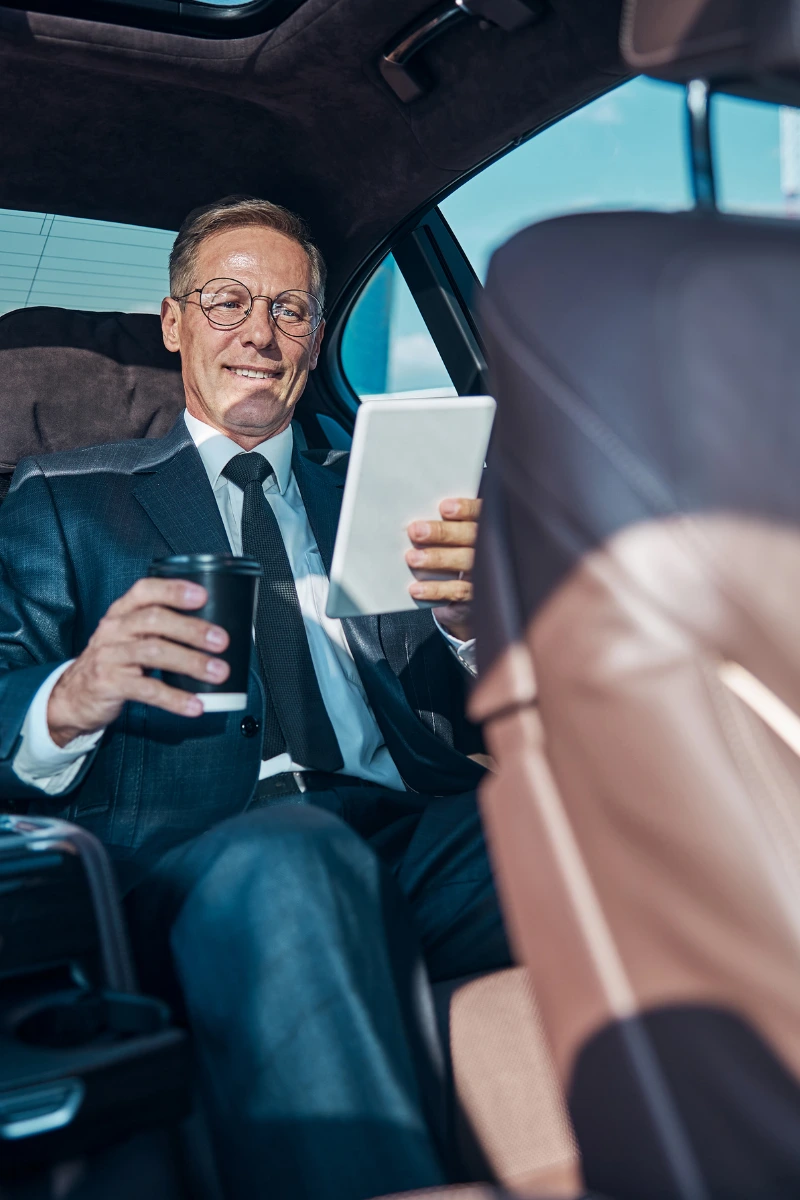 Aurevo chauffeur opening door in front of luxury Roman hotel